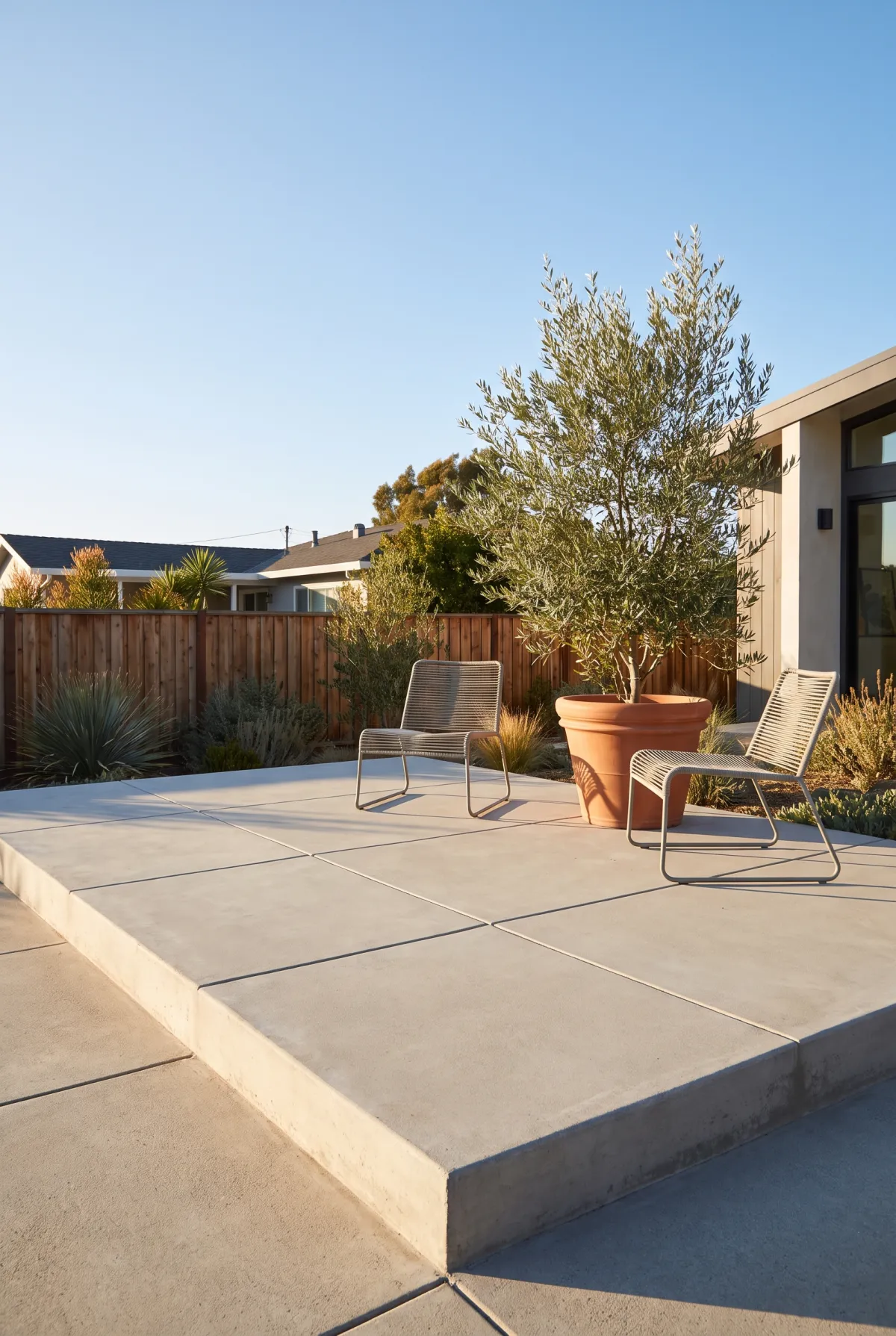 Budget concrete patio with saw-cut grid lines forming a tile pattern