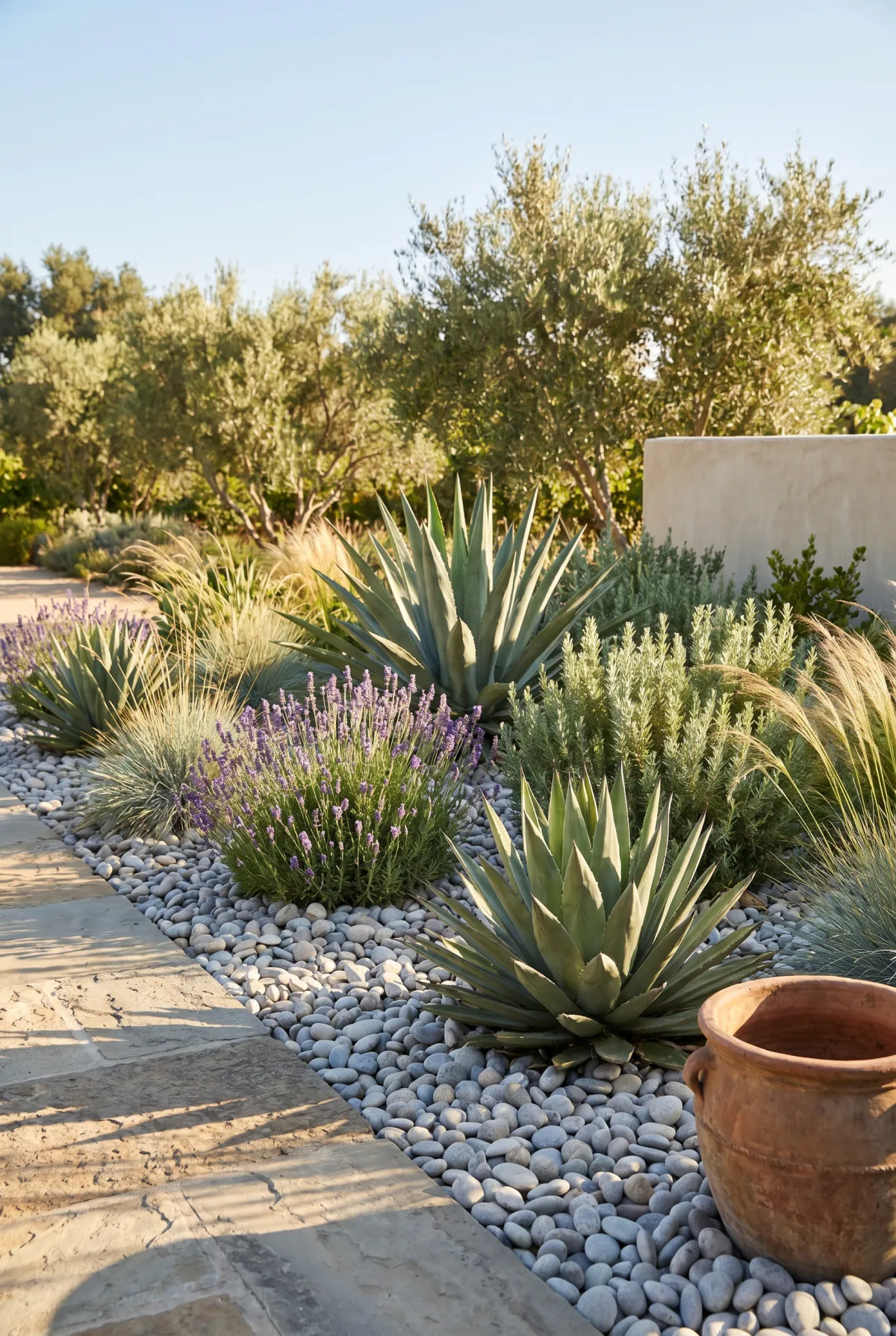 Drought-tolerant garden bed finished with light stone mulch