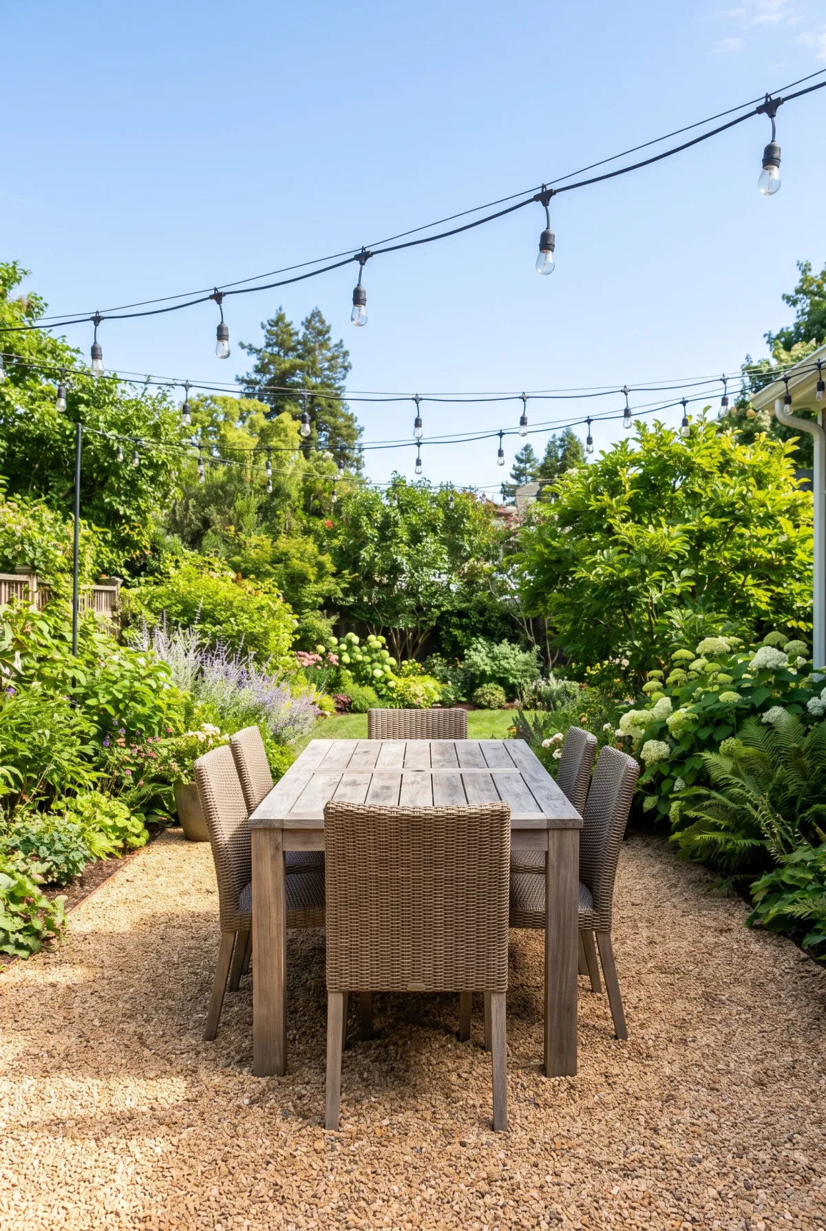 Pea gravel dining patio with string lights