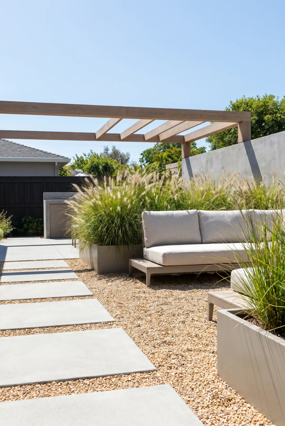 Modern pea gravel patio with concrete pavers and a low sofa
