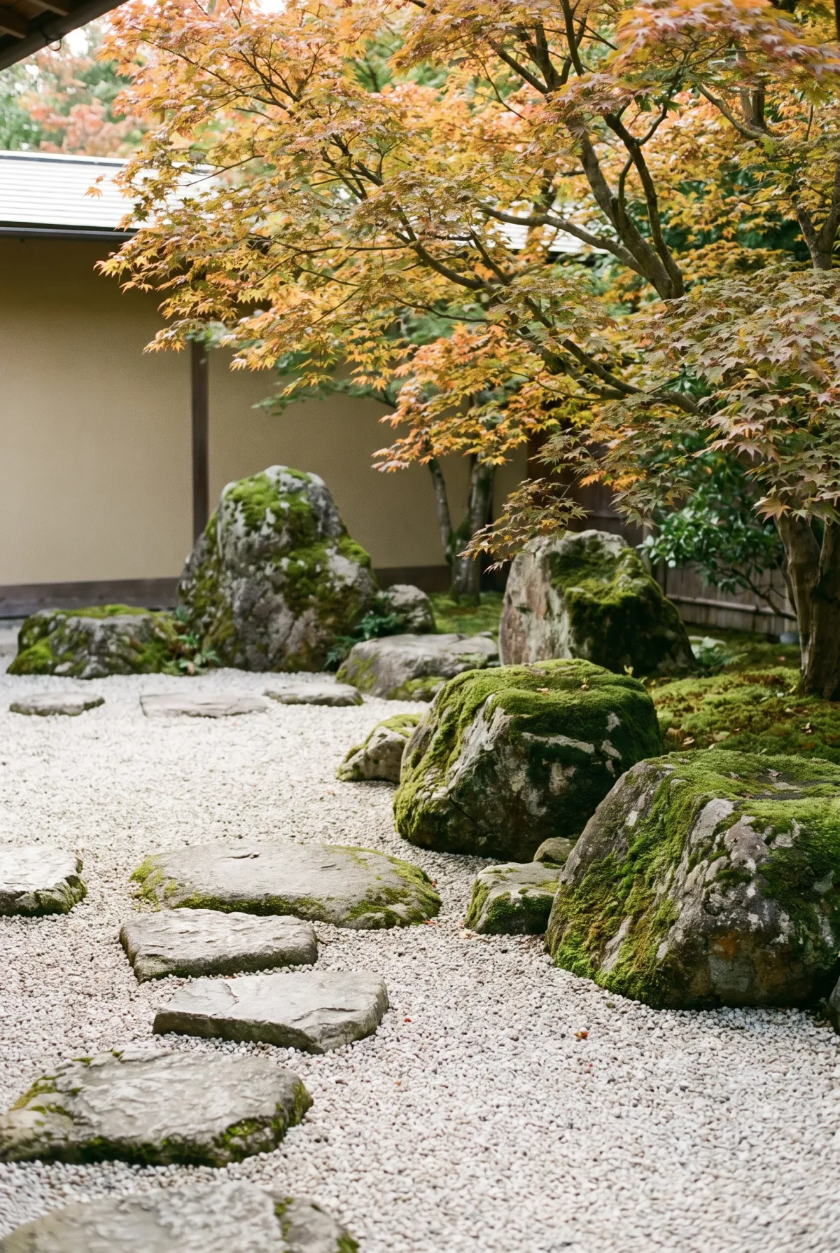 Japanese-style pea gravel garden with boulders and stepping stones